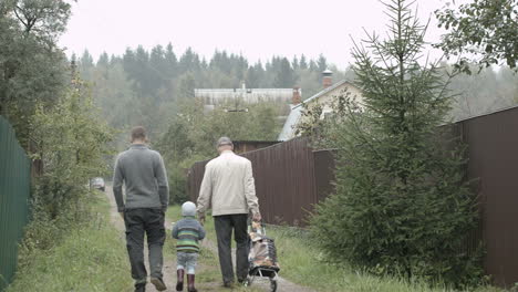 Two-men-and-a-boy-walking-in-the-countryside