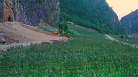 greenery landscape drone shot around manag annapurna region, jcb excavator construction, apple trees devastation farm nepal 4k