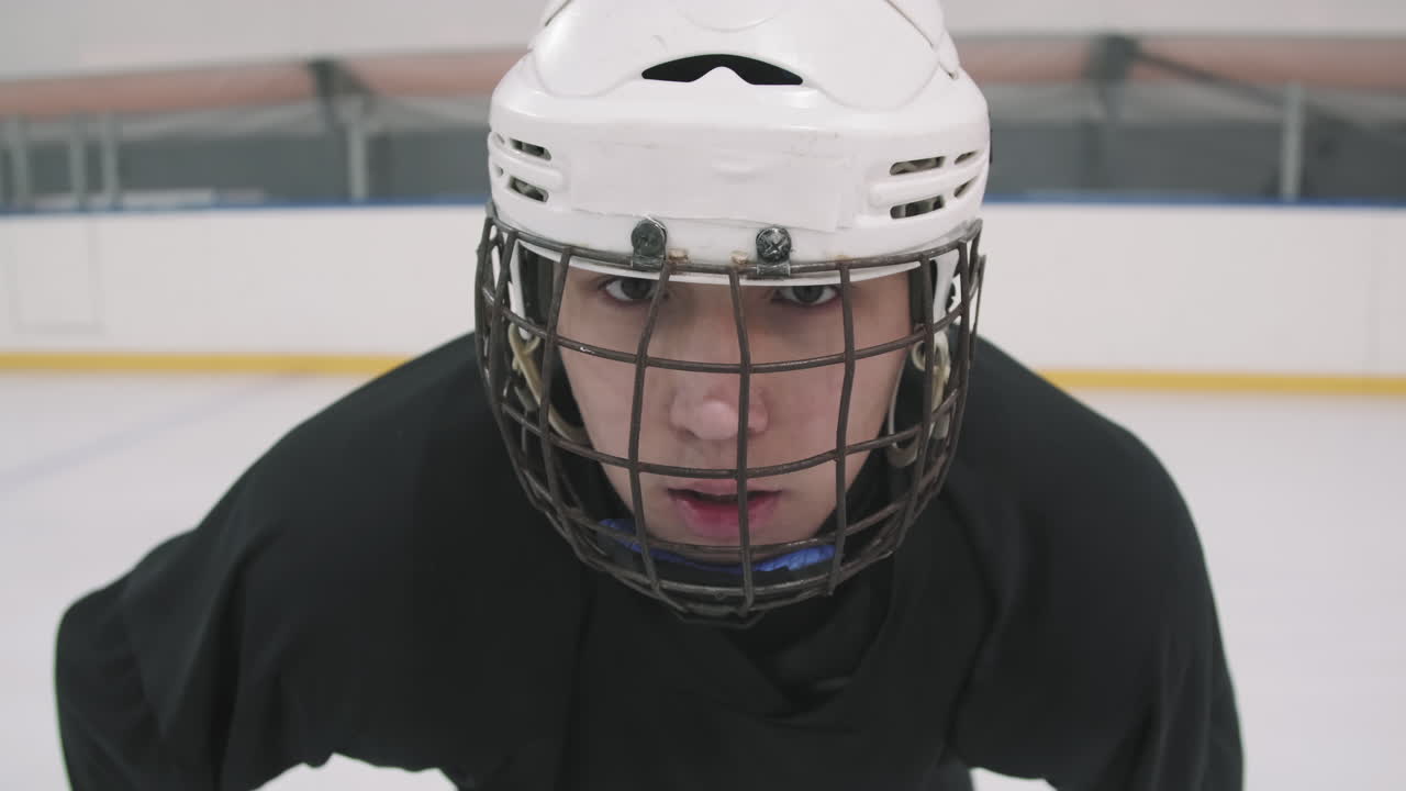 Portrait Of Young Hockey Player In Helmet With Cage