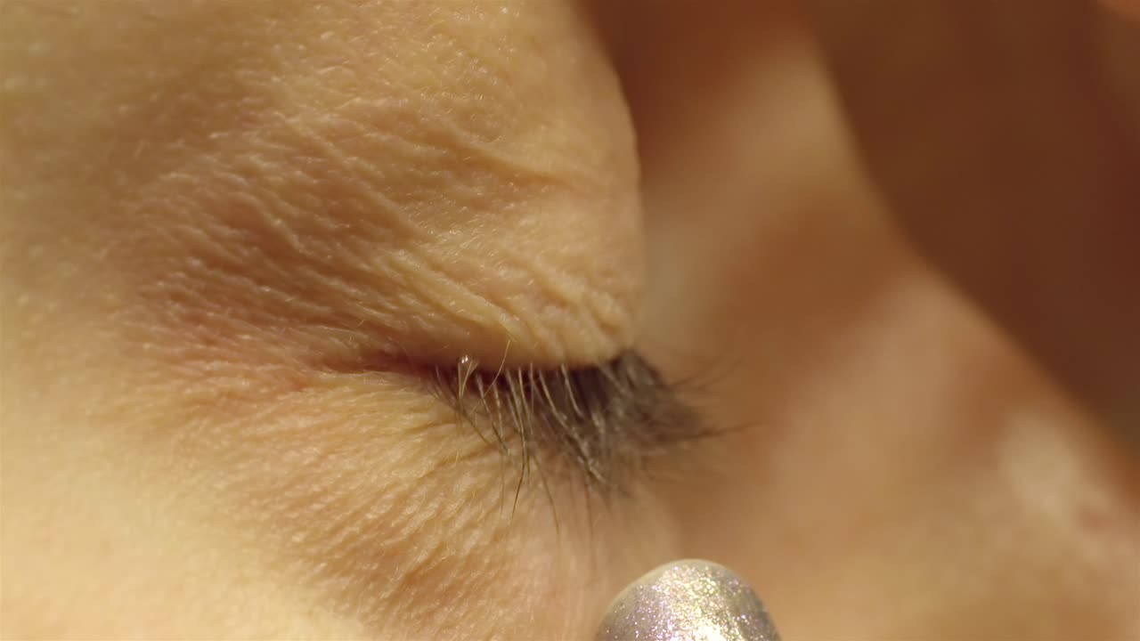 Extreme Close-up Finger Gently Holding Upper Eyelid for Lens Insertion