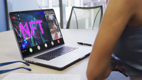 video of biracial woman having nft video call on laptop with diverse coworkers