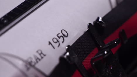 year 1950, typing on white paper in vintage typewriter, close up