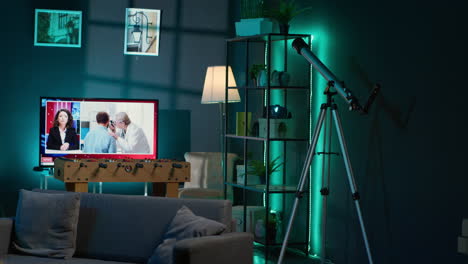 cozy high end apartment illuminated with neon lights and a big tv, home theatre and setup for a young adult. empty loft decorated and equipped with electronics, comfortable space.