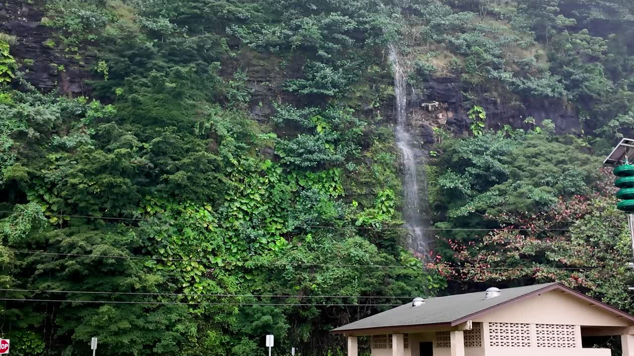 water stream coming down from mountain at Haena Beach Park, Kauai US, a beautiful sandy Haena Beach at Haena Beach Park on the North Shore of Kauai, Hawaii on a cloudy foggy day, popular