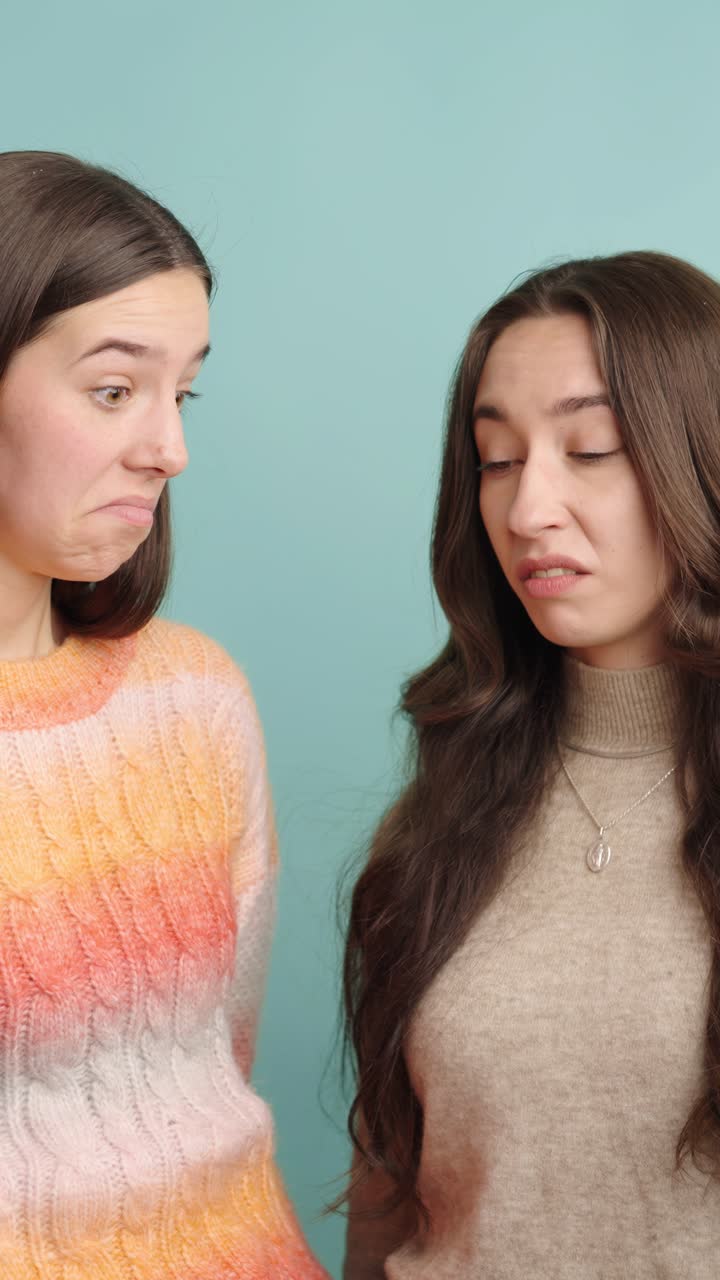 Expressive women sharing confused and disgusted reactions together