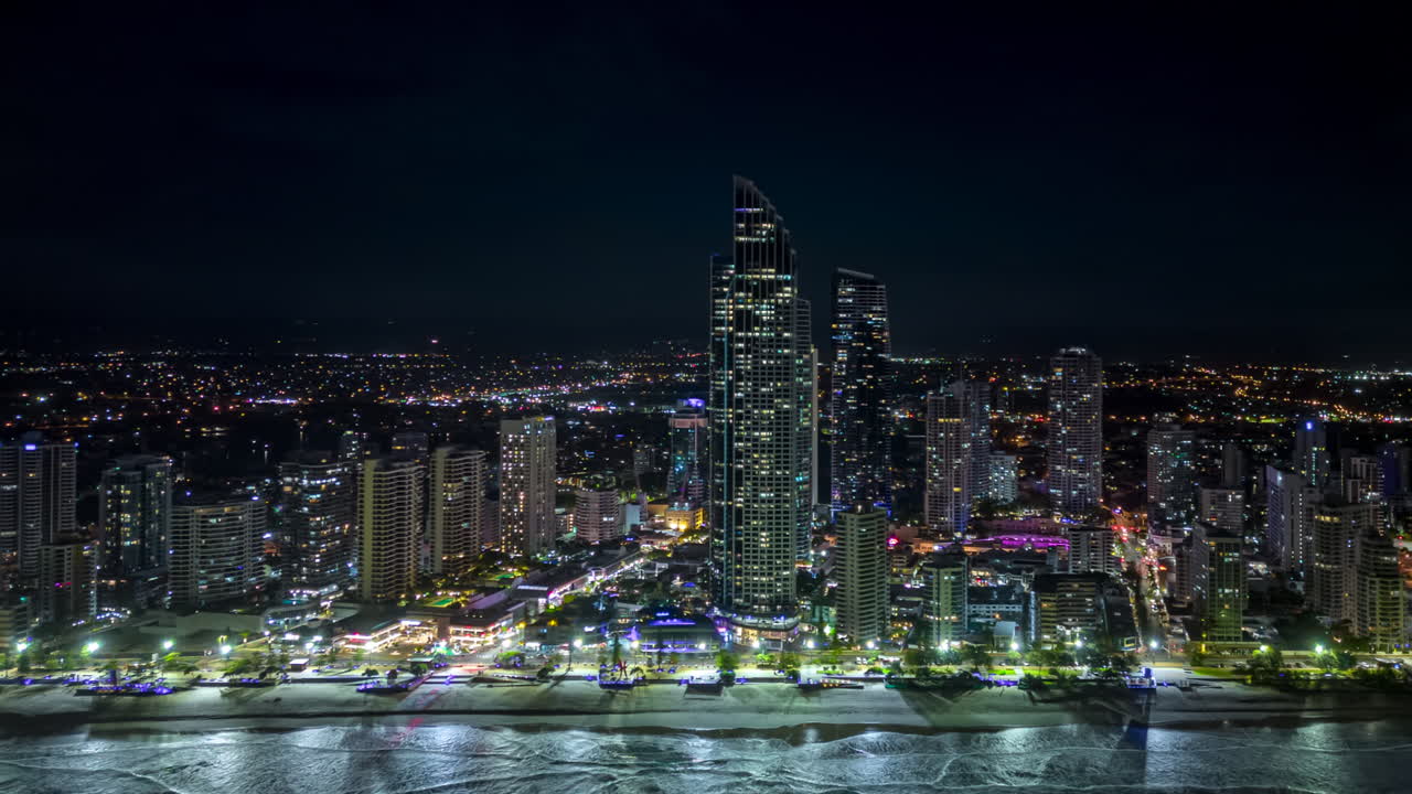 Aerial tracking night hyperlapse along Surfer's paradise skyline, Gold Coast, Australia