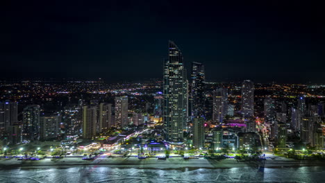 Aerial-tracking-night-hyperlapse-along-Surfer's-paradise-skyline,-Gold-Coast,-Australia