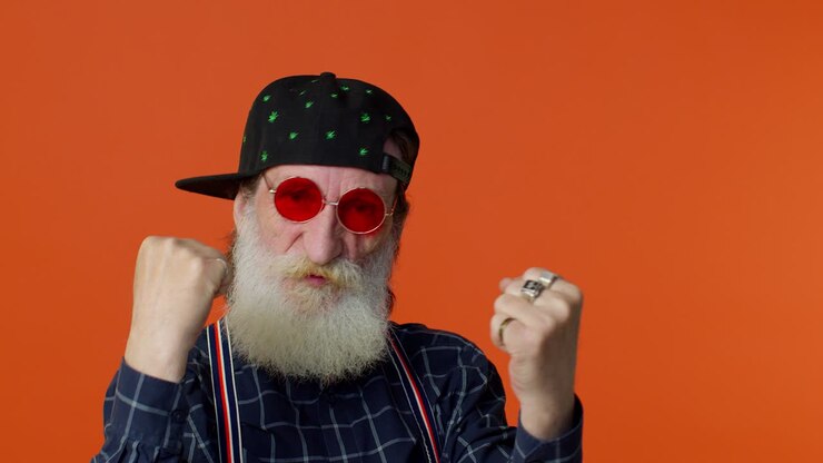 Mature grandfather raising fists in gesture I did it, celebrating success, winning goal achievement