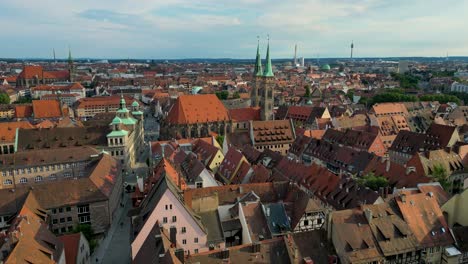 4k aerial drone video of the copper-clad twin spiers on the beautiful st. sebald church in downtown nurnberg, germany