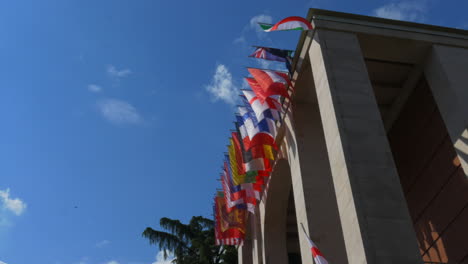 different european flags on top of a art museum in milan