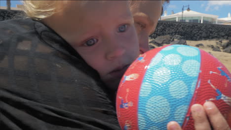 a baby girl with her mother at a seashore