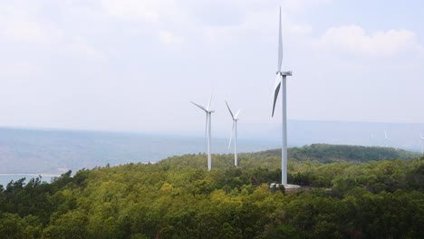 wind turbines rotating in a lush landscape