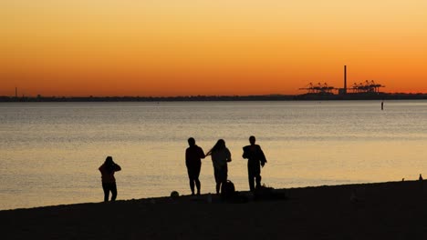 people enjoying sunset at st kilda beach