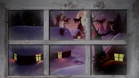 marco de ventana de madera contra la nieve que cae sobre varias casas y árboles en el paisaje de invierno