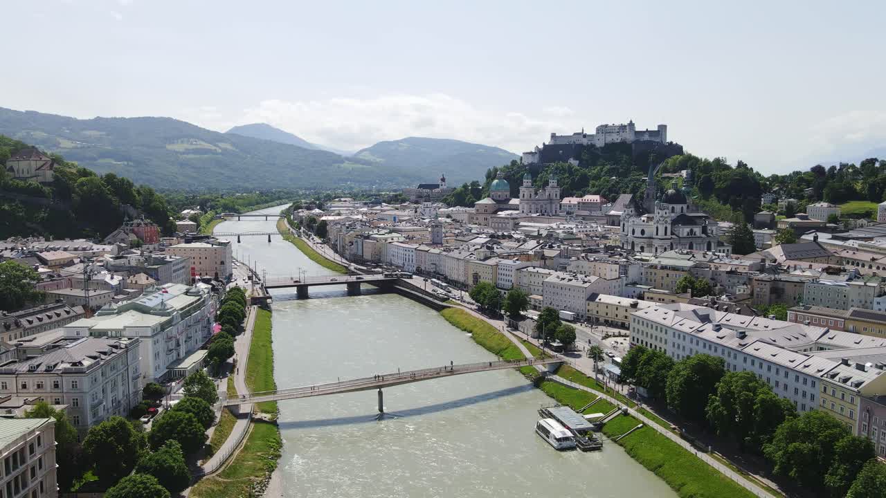 Salzburg’s baroque old town, river shimmer under summer sky with alpine horizon
