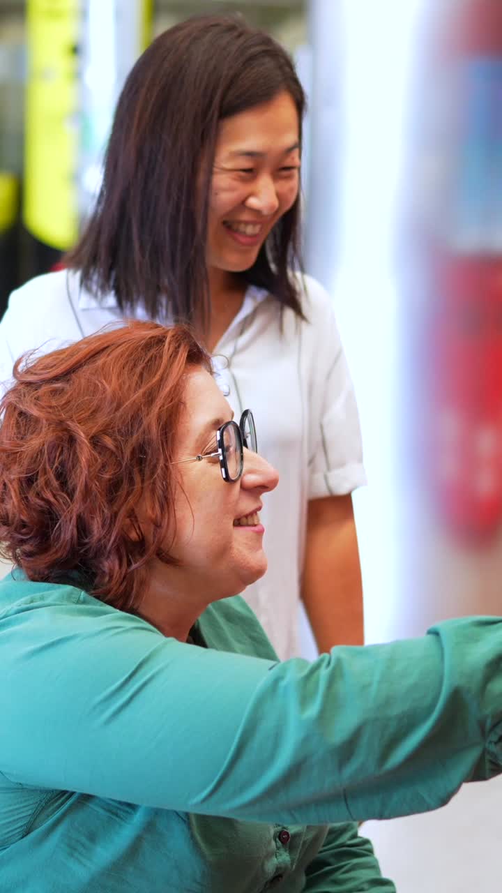 Two women indoors looking at something