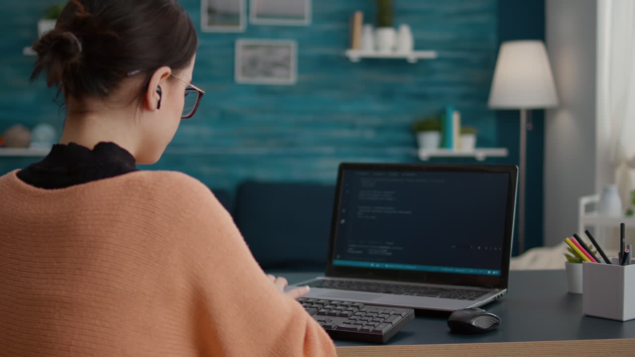 IT student using programming interface and binary code on laptop