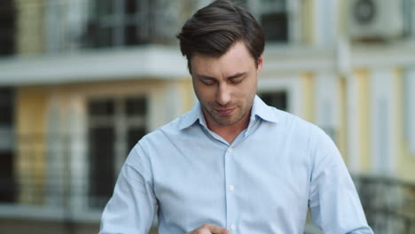 portrait man walking in wireless earphones. man listening to music outdoor