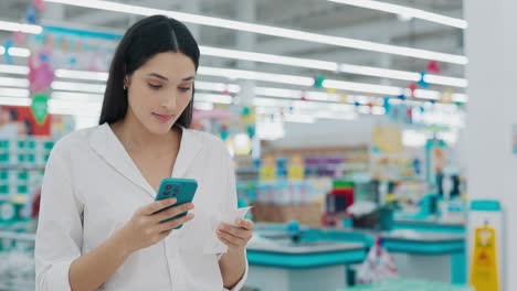 woman checking receipt in supermarket