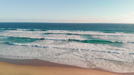 drone view of beautiful sea waves on the beach, aerial view of ocean shoreline, deep blue ocean water and foamy waves
