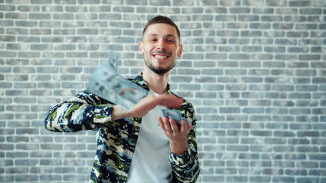 man throwing money in the air