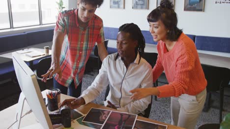 happy diverse business people discussing work during meeting at office