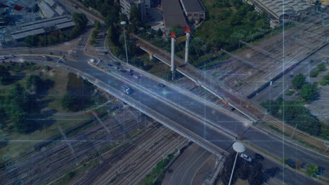 digital network connections overlaying traffic and railway on bridge, aerial view