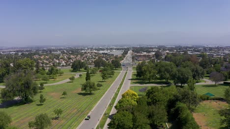 Low-aerial-shot-flying-over-the-entrance-road-to-a-mortuary-in-California