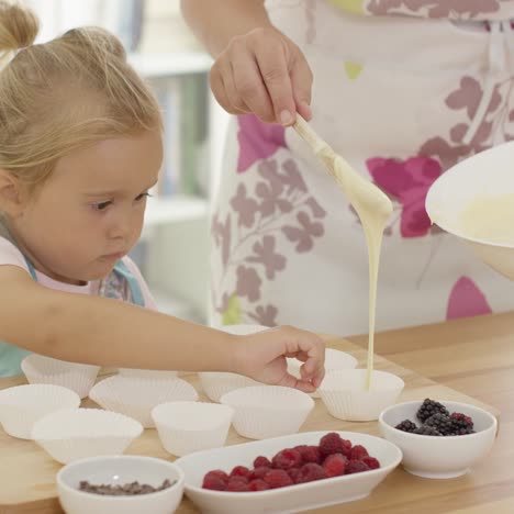 Little-girl-assisting-Mum-with-the-baking