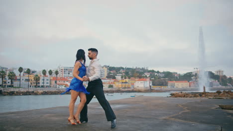 passionate pair performing latin american dance on embanking. couple dancing