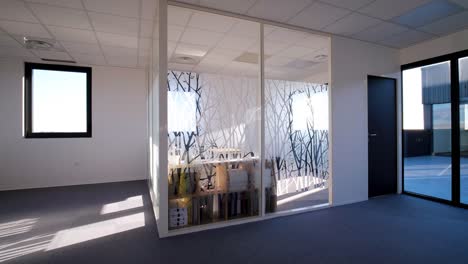 slow orbiting shot of a small office with frosted patterned glass