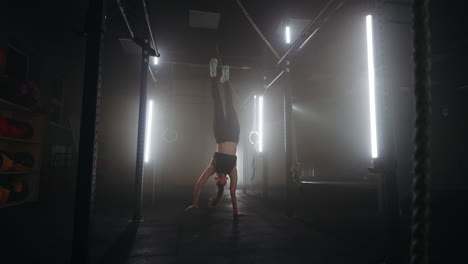 sporty-woman-is-performing-hands-walking-in-fitness-center-training-alone-in-gymnastics-hall