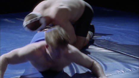 two athletes struggle in a wrestling match