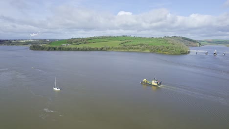 Waterford-Estuary-the-shipping-channel-being-dredged-of-mod-and-sand-at-Cheekpoint-where-the-Suir-and-Barrow-rivers-before-exiting-to-the-Celtic-Sea