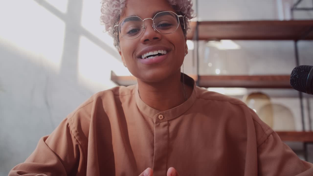 Webcam view of african american female blogger waving hand welcoming people