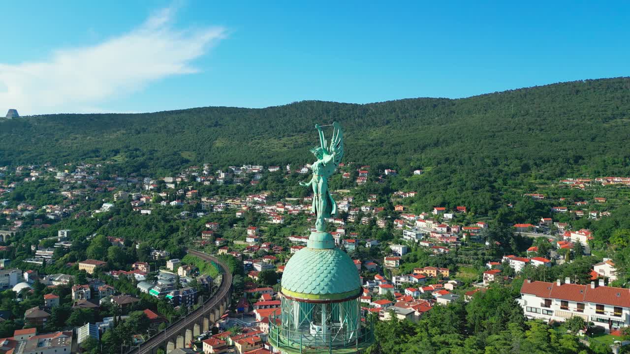 A sweeping aerial of the Victory Lighthouse near Trieste, Italy—where coastal charm meets towering history high above a sea of red-roofed homes.