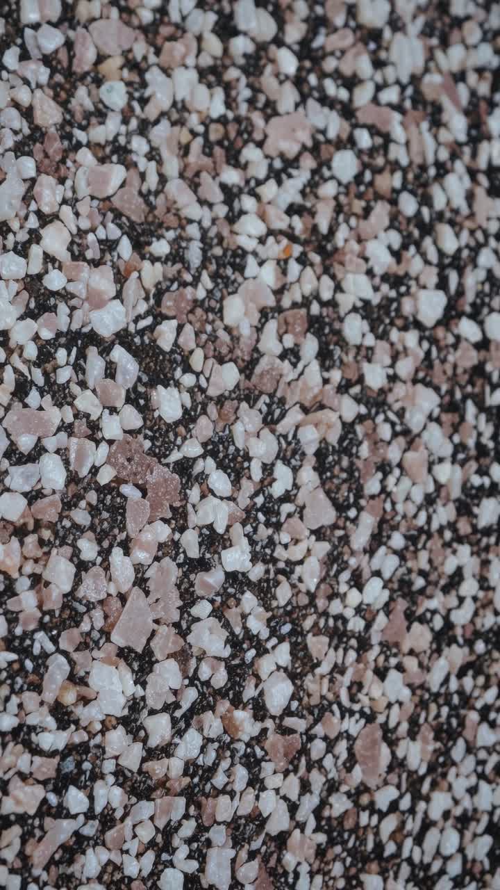 Close-up shot of pink and white pebbles creating a textured surface