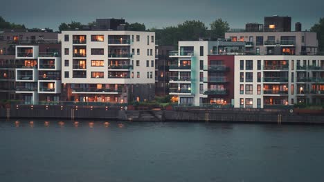 modern residential buildings with brightly lit windows in the coastal quarter of the kristiansand city