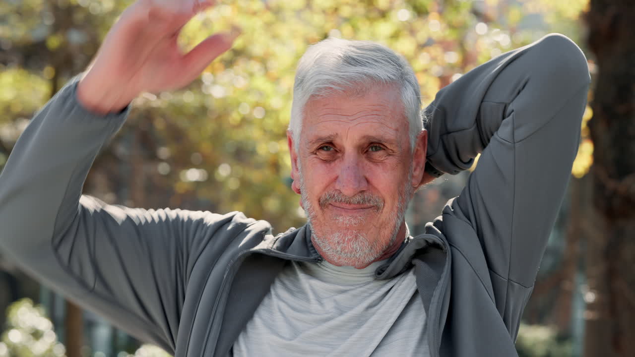 hombre mayor estirando los brazos mientras sonríe al aire libre