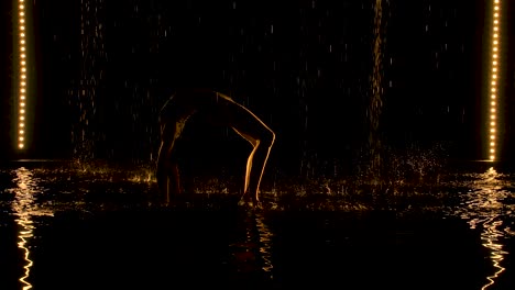 Young woman practices yoga asanas in a dark studio | activity, adult, aqua, aquastudio