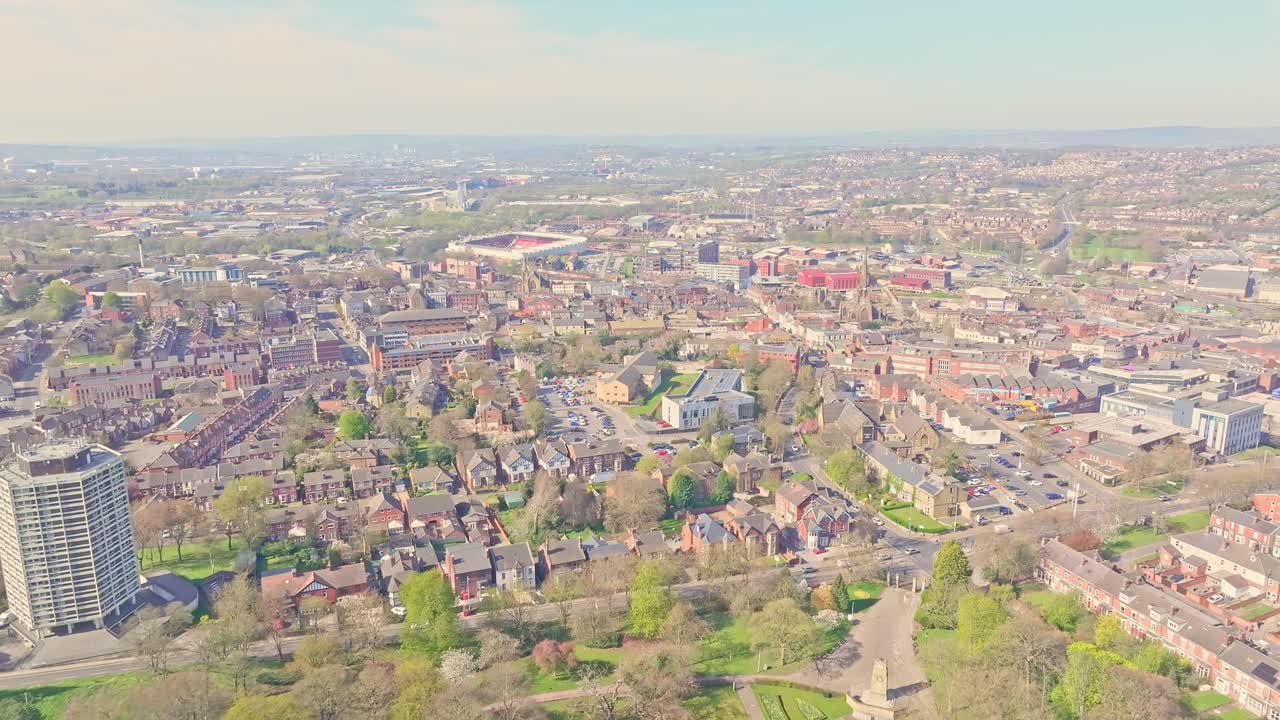 Wide aerial view of Rotherham dense urban landscape with residential housing, green spaces and the iconic Rotherham United Football stadium, South Yorkshire, England