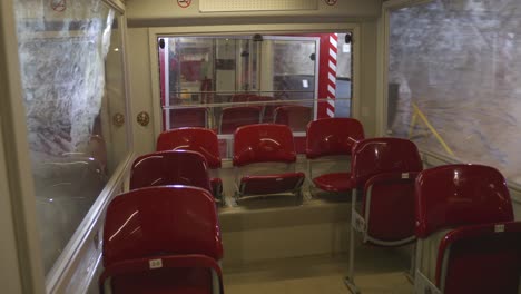 discover the thrilling train ride through a historic underground mine, where visitors enjoy comfortable red seating huge windows, and stunning views of the mining operation.
