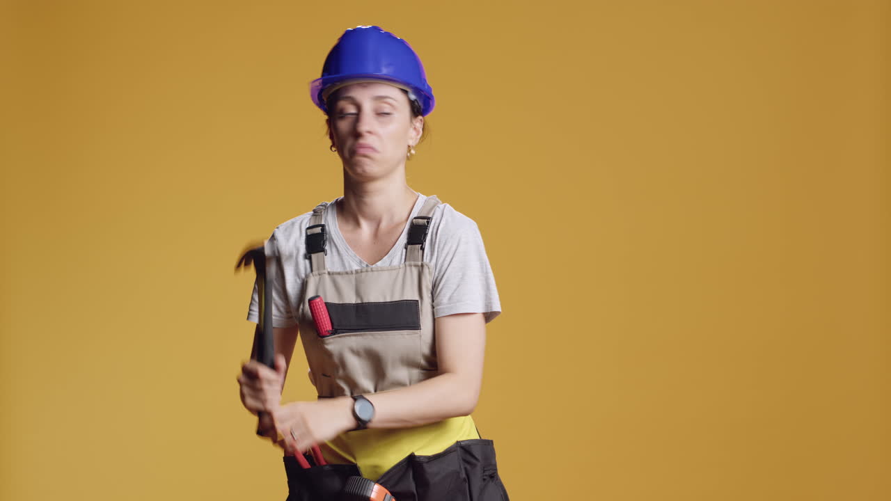 Strong contractor using mechanical hammer to fix nails
