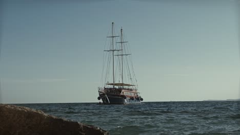 old antique ship anchored at sea on the shore of the beach, vessel background with copy space