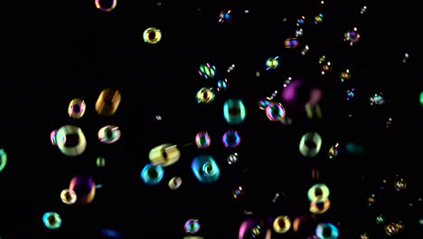 soap Bubbles Start Flying from the Center and Burst Black Backrounds many Small Soap Bubbles Start Flying from the Center and Paw in the Air Black Background