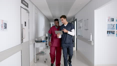 diverse healthcare professionals discuss in a hospital corridor