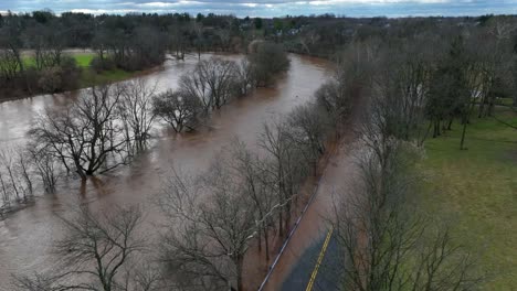 aerial flyover flooded conestoga river after strong rain in lancaster during cloudy day, usa - environmental catastrophe on earth