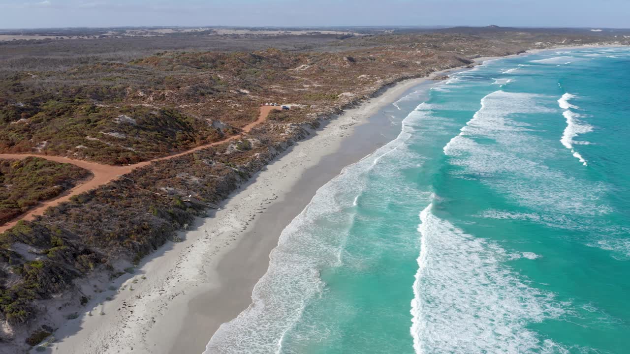 Drone footage of turquoise waves rolling onto the beach at Vivonne Bay, Kangaroo Island, South Australia