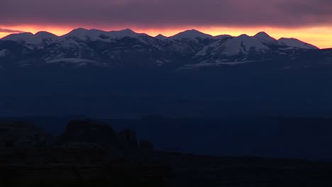 longshot of the la sal mountains silhouetted at goldenhour