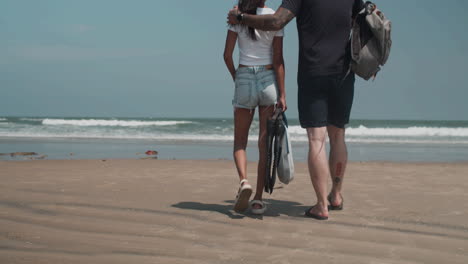 couple carrying diving equipment